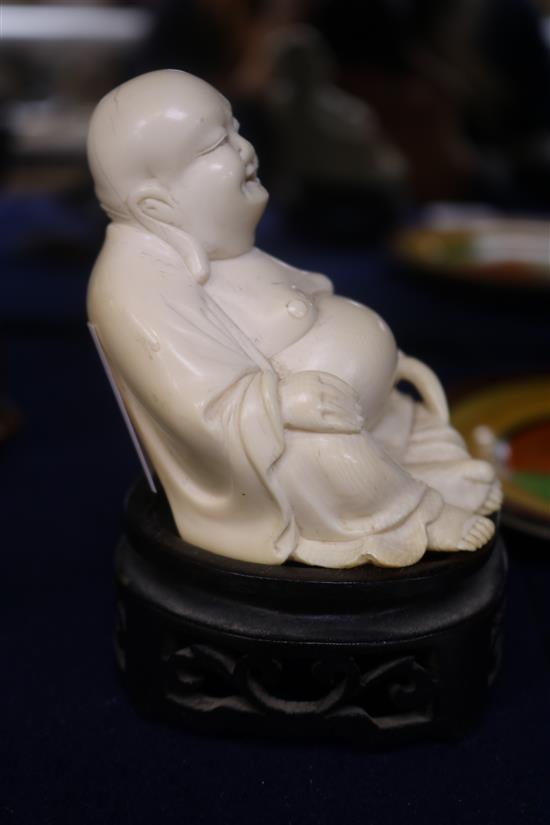 A Chinese ivory figure of Budai wood stand
